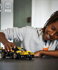 Child playing with Bugatti Bolide Racing Car Building Set For Kids And Teens A Totally Cool Engineering Toy Back To School Gift Collectible Sports Car Construction Kit Ages 9 Plus 42151