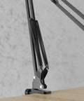 Heavy Duty Microphone Arm Stand With Suspension Boom, Anti Scratch Desk Clamp Up To 2 Inches, Fixed Knob Lock Prevents Sag. Close-up of clamp on desk.