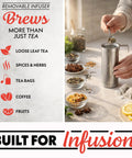 Person using removable infuser with Electric Glass Kettle With 1.7L Capacity, Programmable Tea And Coffee Brewer, 6 Easy To Use Presets