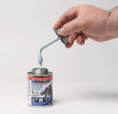 Hand holding a lid with paste from Megaloc Multi-Purpose Thread Sealant Can Blue Liquid Paste 8 Oz 236 Ml One Half Pint Kevlar Reinforced