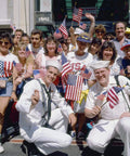 Crowd with 150 Pack Handheld American Flags On Sticks 4x6 Inches With Gold Spearhead For 250th Anniversary, 4th Of July, Memorial Day, Parades And Outdoor Lawn Decor For Backyard Parties