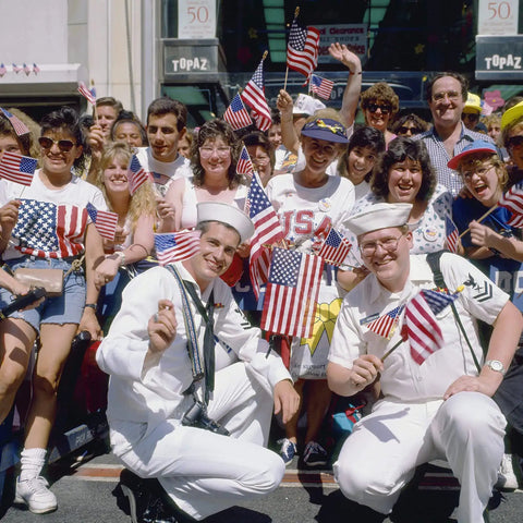 Crowd with 150 Pack Handheld American Flags On Sticks 4x6 Inches With Gold Spearhead For 250th Anniversary, 4th Of July, Memorial Day, Parades And Outdoor Lawn Decor For Backyard Parties