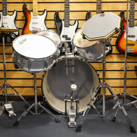 Ultimate Tall Snare Drum Stand With Stick Holder For Kids And Adults Adjustable Height From 26 To 40 Inches Double Braced Stability Fits 10-14 Inch drums, silver finish with surrounding guitars.