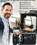 Top Shelf 78 Piece 3D Printer Tool Kit With Tough Storage Case For All FDM And SLA Printers flat open tool kit showcasing various tools against printer backdrop.