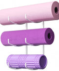 Garage Gym Must Have Space Saving 3-Tier Wall Mount Yoga Mat Rack with pink and purple mats and rollers, white metal organizer