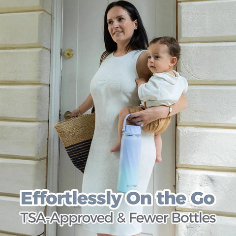 Mom holding baby and Top Shelf Portable Breastmilk Cooler Bottle with heavy duty insulation while exiting home.