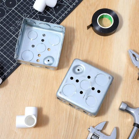 12 Pack 4 Inch Square Electrical Boxes 1-1/2 Inch Deep Galvanized Steel Junction Boxes For Wall Outlets And Wiring 21 Cu In Capacity Silver Finish Screws Not Included, shown open on a table with tools