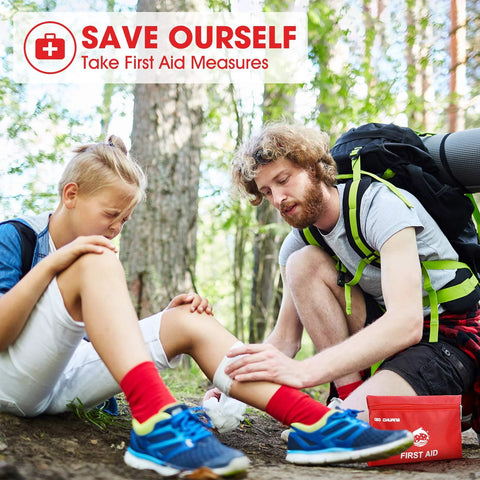 Small red travel first aid kit with 87 pieces; outdoors on hiking trail as man treats girl's knee
