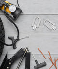 3 Piece Auto Dent Puller Kit with aluminum ring tools on a wooden surface, shown with a tire and repair accessories