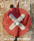 Man climbing rock surface with "Not for Climbing" warning, not using 3 Inch Black Aluminum Carabiner Clips 10 Pack Dual Style D Ring And Snap Hook.