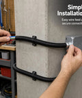 Built Tough Workhorse Corrugated Flexible Conduit Pipe With Compression Fitting Connector For Electrical Cable Routing And Wiring Harness Protection Rated At 20 Bar Pressure In A Sturdy 19 Millimeter Coil installed on a wall.