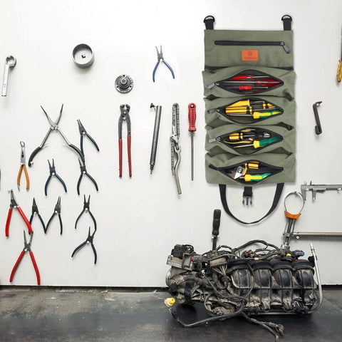 Sturdy Canvas 16oz Tool Roll Up Bag for wrenches and tools displayed open on wall with various hand tools