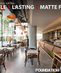 Interior view of a modern café with matte concrete floor, tables, chairs, and a well-stocked bar to highlight the Straight Up Tough Matte Concrete Floor Coating For Garages Stops Oil Gas Grease And Tires Blocks Surface Dust Delivers Self Priming Heavy Duty Protection Three Gallon Complete Kit.
