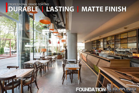 Interior view of a modern café with matte concrete floor, tables, chairs, and a well-stocked bar to highlight the Straight Up Tough Matte Concrete Floor Coating For Garages Stops Oil Gas Grease And Tires Blocks Surface Dust Delivers Self Priming Heavy Duty Protection Three Gallon Complete Kit.