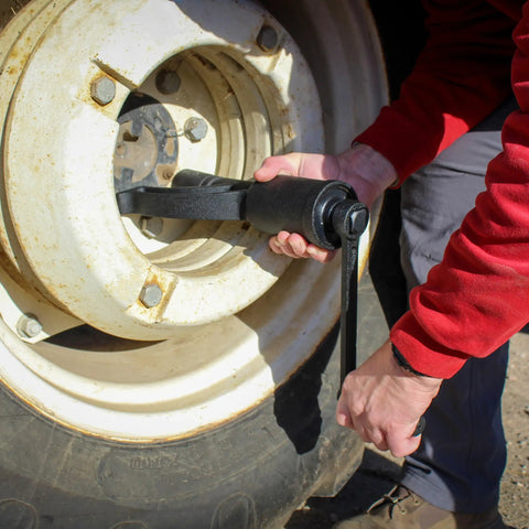 Person using Roadside Ready 1 Inch Drive Torque Multiplier Wrench For Quick Removal Of Rusted Lug Nuts on truck wheel