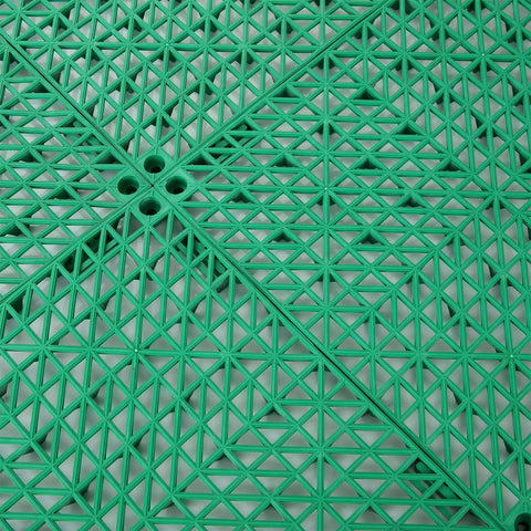 Interlocking Rubber Floor Tiles Eleven Point Six Inch Cushioned Mats With Drain Holes Non Slip Waterproof Green Surface Close-up