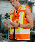 High Vis FR Safety Vest Zip Front Flame Resistant Workwear ANSI Class 1 Reflective Tape NFPA 70E cotton twill worn by man reading.