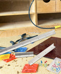 Pro Stained Glass Layout Block System With Sixty Mixed Color Push Pins Tracing Board on workbench with colored glass pieces.