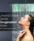 Woman enjoying shower from 12 Inch Black Square LED Rain Shower Head With Brass Overhead Spray For Bathroom, LED lights on