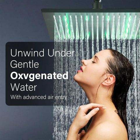 Woman enjoying shower from 12 Inch Black Square LED Rain Shower Head With Brass Overhead Spray For Bathroom, LED lights on
