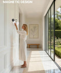 Woman adjusting HOJOYRI Black Recharge Battery Operated Wall Sconces Set of Two with Remote in modern hallway.