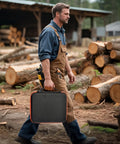 Man carrying Heavy Duty Chainsaw Chain Storage Case Organizer For 6 To 12 Chains And File Kit Accessories in a lumberyard