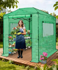 Woman standing in 8x6 Portable Walk In Greenhouse Pop Up Indoor Outdoor Garden Shelter Kit With Zippered Doors And Windows PE Cover