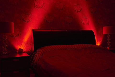 Plug In Wall Sconce Uplighter With GU10 Spotlight Wash Light illuminating a bedroom wall with red ambient glow