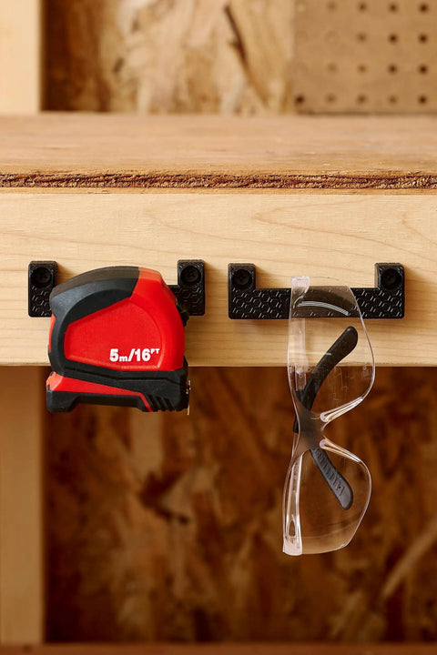 Rugged Tape Measure Holder For Garage Organization, Keeps Tools Handy On Ladder Or Workbench, Grab-And-Go Quick Install Tool Hook Pack Of 4, Built To Last, Versatile, Yellow securing tape measure and safety glasses on workbench