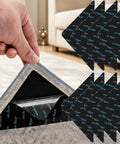 Person applying Eight Piece Triangle Rug Pads Set 70x70mm No Slip Dual Sided Adhesive Pads to a rug on the floor.