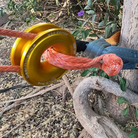 G.O.L.D. Snatch Recovery Ring for Off Road Recovery, 48,000 Lbs MBS, 24,000 Lbs WLL in use with orange synthetic shackle outdoors