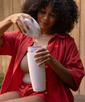Premium Portable Breast Milk Cooler Built To Keep Pumped Storage Ice Cold For Up To 24 Hours, woman pouring milk into cooler.