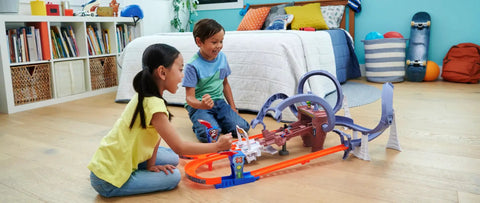 Children playing with Hot Wheels RacerVerse Spider-Man Web-Slinging Speedway Track Set With Spider-Man And Black Panther Epic Multi-Lap Race