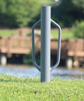 Heavy Duty 24 Inch Post Driver Rammer For Installing Fence Posts Up To 2.5 Inches with ergonomic closed handles, outdoor view.