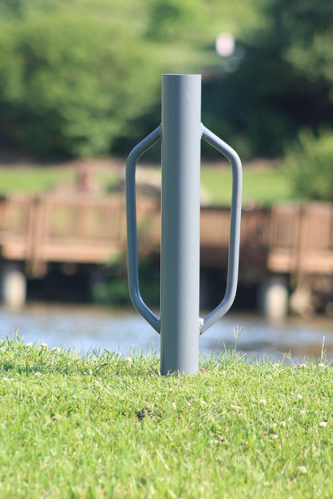 Heavy Duty 24 Inch Post Driver Rammer For Installing Fence Posts Up To 2.5 Inches with ergonomic closed handles, outdoor view.
