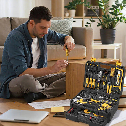 Man using screwdriver from 339 Piece Tool Set For Home And Auto Repair, Comprehensive Hand Tool Kit With Wrenches, Sockets, Pliers, Screwdrivers, Hammer, Tape Measure, Drill Bits, Hex Keys, And More For DIY Projects And Weekend Fixes on wood furniture.