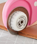 Close-up of 45mm Rotary Cutter Blades 10 Pack Compatible With Olfa And Fiskars Replacement cutting brown leather fabric.