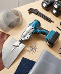 Aolidsive Cordless Metal Shear Delivering 400Nm Torque For Bl1830 Battery on workbench with metal sheets, leather, and tools.
