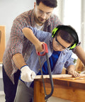 Child using a saw wearing Kids Noise Cancelling Ear Muffs 27NRR in green, adjustable ear protection for safe woodworking.