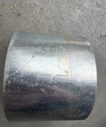 Rock Solid Four Inch Galvanized Steel Conduit Coupler For Electrical Raceway Systems Pro Grade Raceway Splice Sleeve on a surface.
