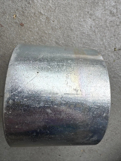 Rock Solid Four Inch Galvanized Steel Conduit Coupler For Electrical Raceway Systems Pro Grade Raceway Splice Sleeve on a surface.