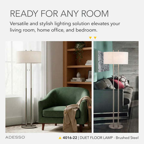 Brushed Steel Floor Lamp With Ivory Fabric Shade, Dual Pull Chain And Double Socket Design beside green chair in living room.