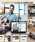 Man playing guitar in front of laptop with webcam and phone setup for video streaming and transmission; focus on technology setup.