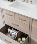 Vanity with open drawer showing Antique Brass Cabinet Pulls Set, Solid Zinc Alloy Drawer Handles, 3.8 Inch Center, 6 Pack.