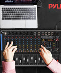 Person using 12 Channel Console Style DJ Mixer With Bluetooth And USB Audio Interface, 8 XLR And Combo Inputs, Sub Output