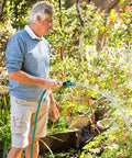 Man using Easy Snap Quick Connect Kit For Garden Hoses With Three Quarter Inch Male And Female Plastic Fittings With Shutoff Valve Water Stop And Lock Hassle Free Attachments For Sprinklers Nozzles And Spigots Five Sets Ten Pieces in garden
