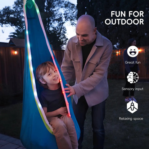 Child enjoying Light Up Pod Swing Seat For Kids With LED Lights, Sensory Hammock Chair In Cotton, outdoor play, blue
