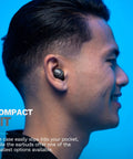 Profile view of person wearing totally wireless earbuds featuring instant plug and play pairing, compact design.