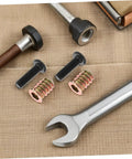 Close-up of 50Pc Wood Threaded Insert Nut Kit with Hex Bolts for DIY Furniture Assembly, showing inserts, bolts, and wrench.