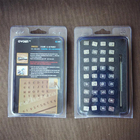 Leather Stamp Kit 37 Piece Set With One Eighth Inch Tall Number And Alphabet Stamps Steel Handle Pro Grade For Leathercraft Personalizing Wallets Belts Bags Straps And DIY Gifts in retail packaging showing stamps and handle.